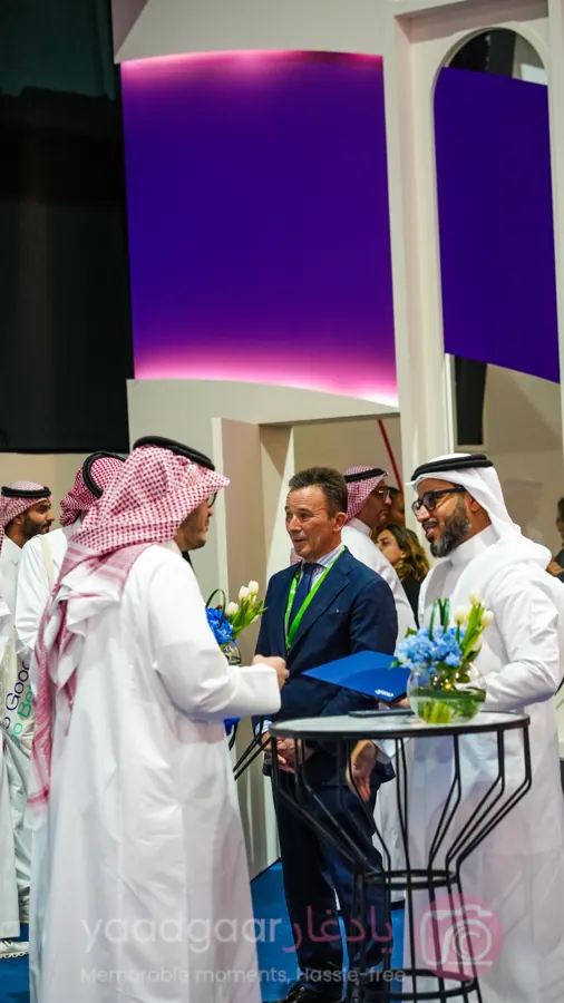 Exhibitors meeting visitors at a trade show