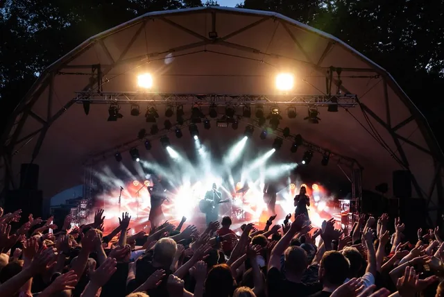 Live event audience in atmospheric stage lighting